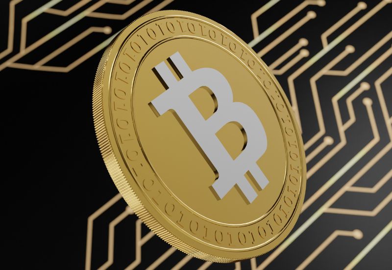Golden Bitcoin above Electronic Module